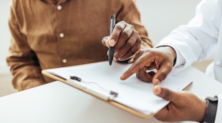 Man filling out patient forms